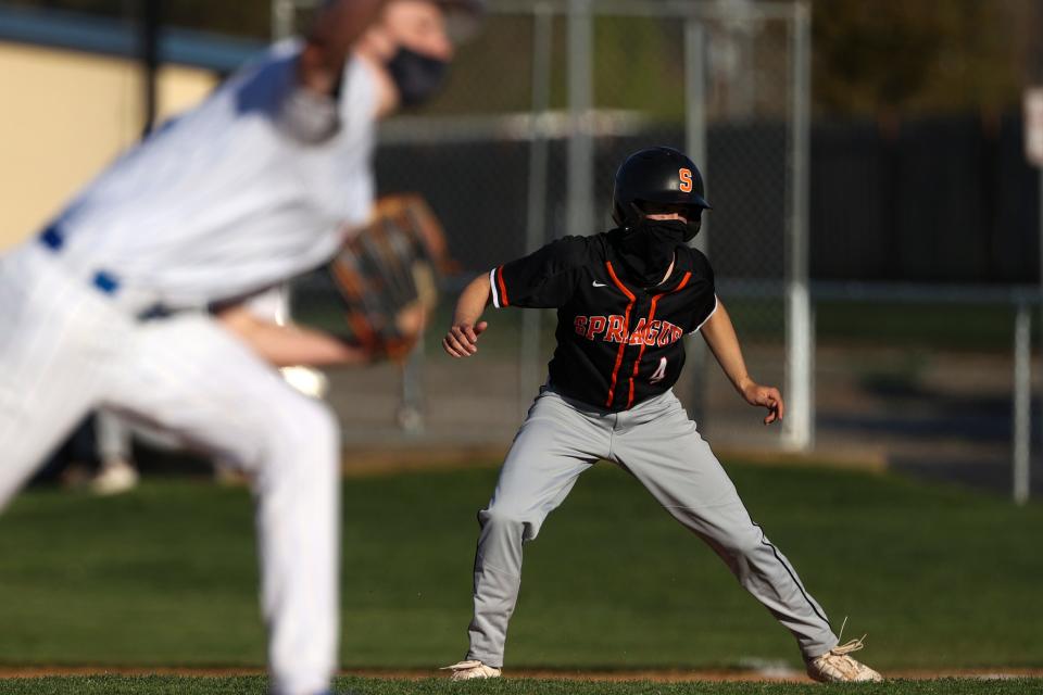 Sprague's Brandon Stinnett (4) makes a move to second base as McNary's Logan Ready (18) pitches during the game at McNary High School in Keizer, Oregon on Friday, April 16, 2021.