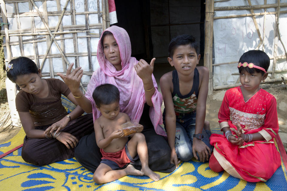 Rohingya refugee woman Johara, 30, a mother of five children, speaks to the Associated Press in Unchiprang refugee camp near Cox's Bazar, in Bangladesh, Friday, Nov. 16, 2018. Normal life returned to a Rohingya Muslim refugee camp in Bangladesh on Friday a day after government officials postponed plans to begin repatriating residents to Myanmar when no one volunteered to go. Johara, who goes by one name, said her husband left to find his parents at another camp after the family found out they were on the government's repatriation list. Johara's husband left with their 6-year-old daughter, who was traumatized after witnessing Myanmar soldiers ransack her home village. (AP Photo/Dar Yasin)