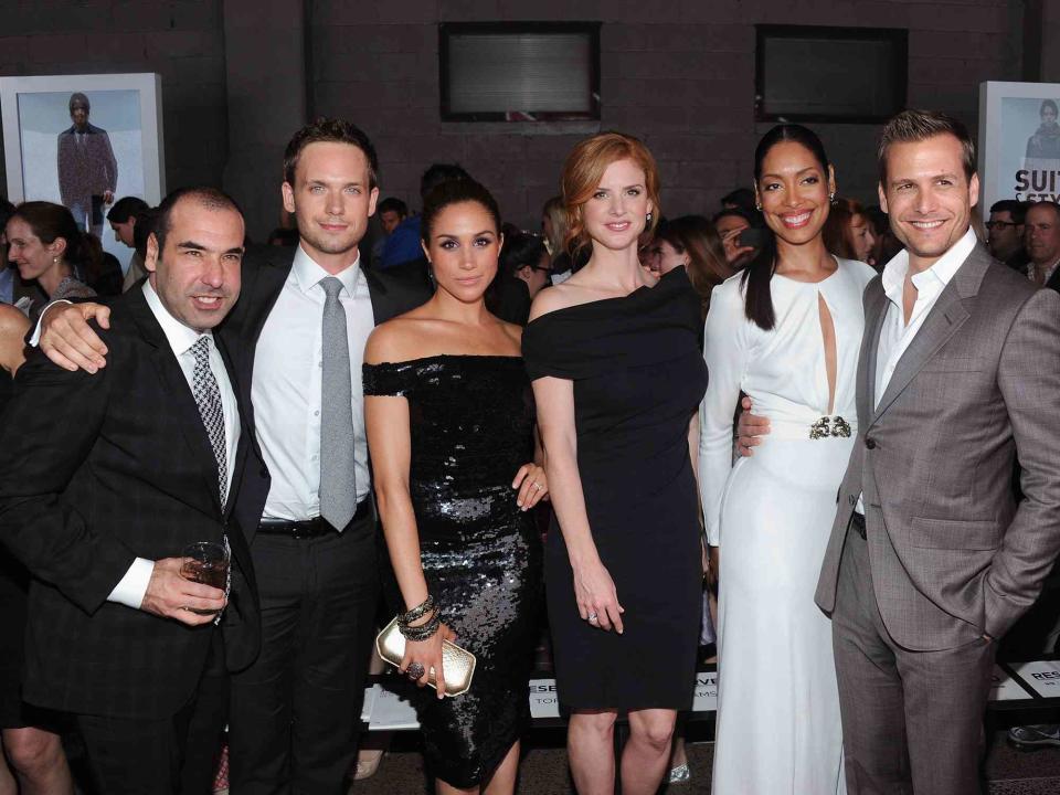 <p>Jamie McCarthy/Getty</p> Rick Hoffman, Patrick J. Adams, Meghan Markle, Sarah Rafferty, Gina Torres and Gabriel Macht of Suits attend USA Network and Mr Porter.com Present "A Suits Story"