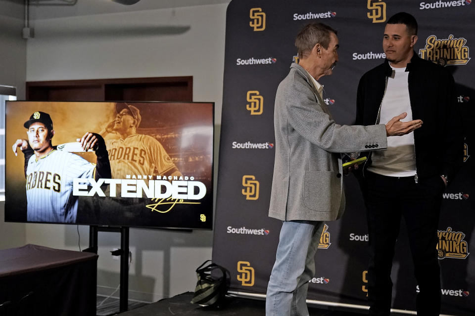 San Diego Padres third baseman Manny Machado talks with owner Peter Seidler after a news conference to discuss his 11-year contract extension Tuesday, Feb. 28, 2023, at the team's spring training baseball facility in Peoria, Ariz. (AP Photo/Charlie Riedel)