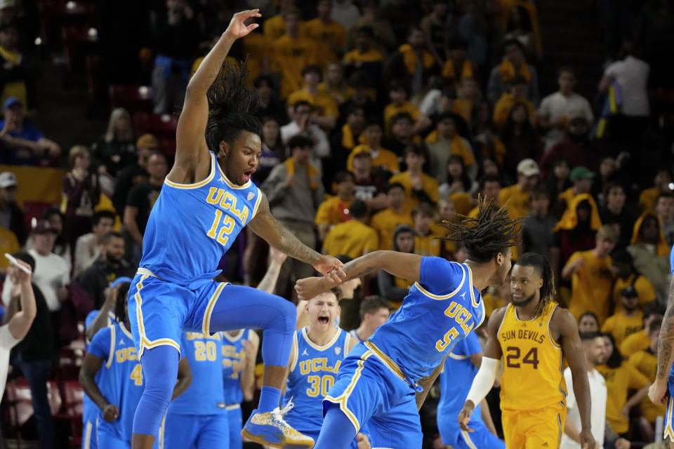 UCLA guard Sebastian Mack (12), guard Brandon Williams (5) and guard Jack Seidler (30) celebrate a win as Arizona State forward Bryant Selebangue (24) walks off the court as time expires in second half of an NCAA college basketball game Wednesday, Jan. 17, 2024, in Tempe, Ariz. UCLA won 68-66. (AP Photo/Ross D. Franklin)