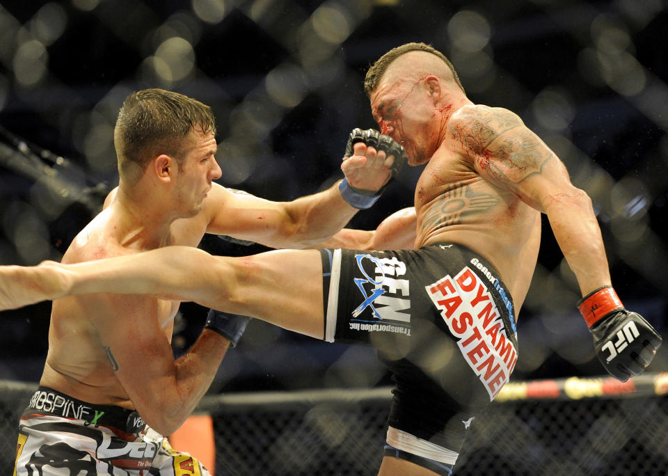 Myles Jury lands a punch on Diego Sanchez during a UFC 171 mixed martial arts lightweight bout, Saturday, March. 15, 2014, in Dallas. Jury won by decision. (AP Photo/Matt Strasen)