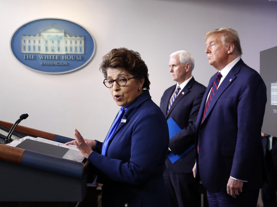 FILE - In this Thursday, April 2, 2020 file photo, Jovita Carranza, administrator of the Small Business Administration, speaks about the coronavirus in the James Brady Press Briefing Room of the White House n Washington, as Vice President Mike Pence, President Donald Trump listen. Millions of small businesses are expected to apply for a desperately needed rescue loan Friday, a stern test for a banking industry that has had less than a week to prepare for the deluge. Small businesses will be seeking loans from the $349 billion Paycheck Protection Program, which was put in place to help them retain workers and pay bills during the coronavirus pandemic. (AP Photo/Alex Brandon, File)