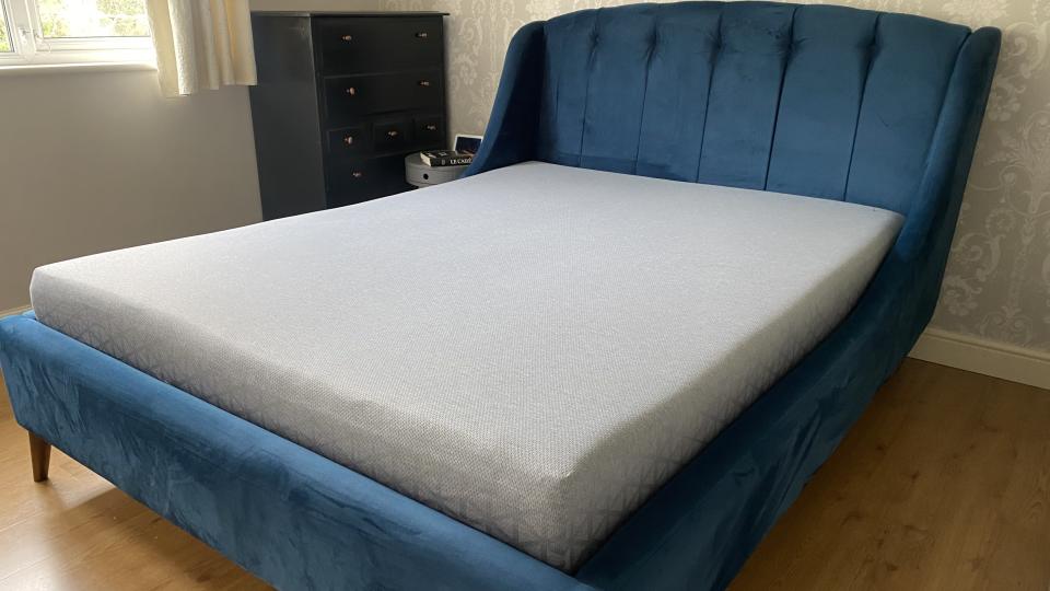 A fully formed Zoma Mattress on a king size platform