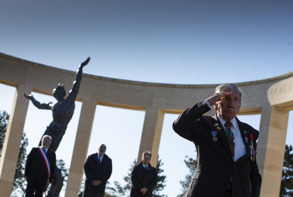 Charles Norman Shay, D-Day WWII veteran and Penobscot Elder from Maine, salutes after laying a wreath during a D-Day 76th anniversary ceremony at the Normandy American Cemetery in Colleville-sur-Mer, Normandy, France, Saturday, June 6, 2020. Due to coronavirus measures many ceremonies and memorials have been cancelled in the region with the exception of very small gatherings. (AP Photo/Virginia Mayo)