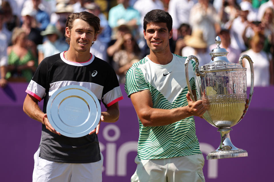 Alex De Minaur and Carlos Alcaraz pose with their trophies.