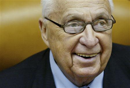 Israeli Prime Minister Ariel Sharon smiles as he speaks during the weekly cabinet meeting at his Jerusalem office in this January 2, 2005 file photo. REUTERS/Kevin Frayer/Pool/Files