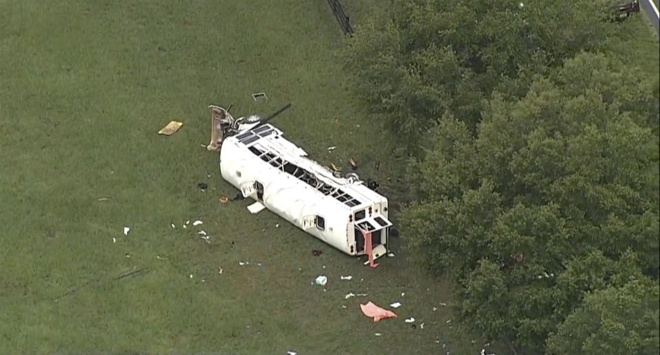 Emergency personnel work the scene of a deadly crash on Tuesday, May 14, 2024 in Marion County, Fla. The Florida Highway Patrol says a bus carrying farmworkers in central Florida has overturned, killing several people and injuring other passengers. Authorities say the bus was transporting farmworkers on Tuesday morning when it collided with a truck and swerved off a road in Marion County, north of Orlando. (WFTS via AP)