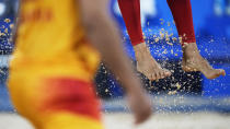 Feet and sand fly during the beach volleyball match between Norway and Spain at the 2020 Summer Olympics, Monday, July 26, 2021, in Tokyo, Japan. (AP Photo/Petros Giannakouris)