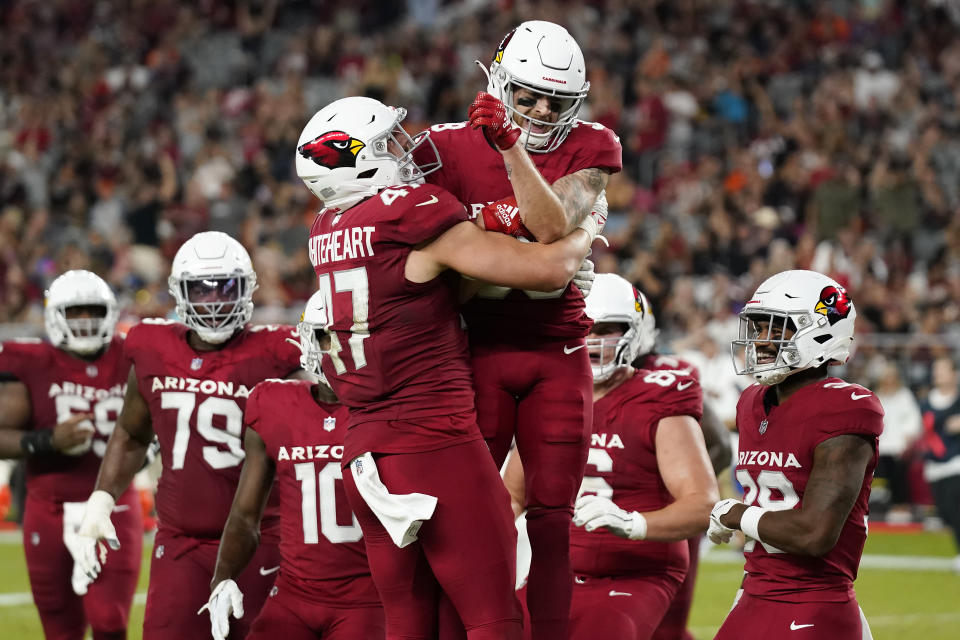 Arizona Cardinals wide receiver Kaden Davis, top, celebrates with tight end Blake Whiteheart (47) and teammates after scoring against the Denver Broncos during the second half of an NFL preseason football game in Glendale, Ariz., Friday, Aug. 11, 2023. (AP Photo/Ross D. Franklin)