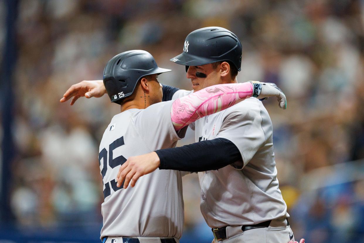 May 12, 2024; St. Petersburg, Florida, USA; New York Yankees second baseman Gleyber Torres (25) is congratulated by first baseman Anthony Rizzo (48) after hitting a three run home run against the Tampa Bay Rays in the eighth inning at Tropicana Field. Mandatory Credit: Nathan Ray Seebeck-USA TODAY Sports