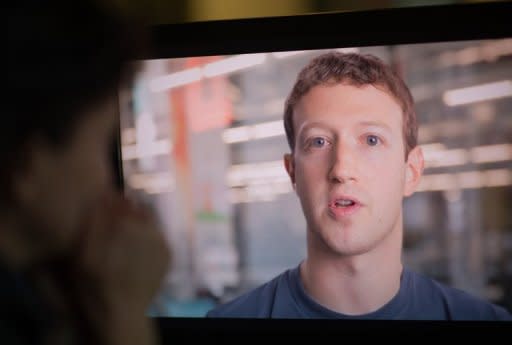 A woman watches Facebook founder and CEO Mark Zuckerberg speaking in a promotional video ahead of the company's IPO, in Washington on May 8. The question of privacy and the use of personal data is a key issue for Facebook as the booming social network prepares to list on Wall Street