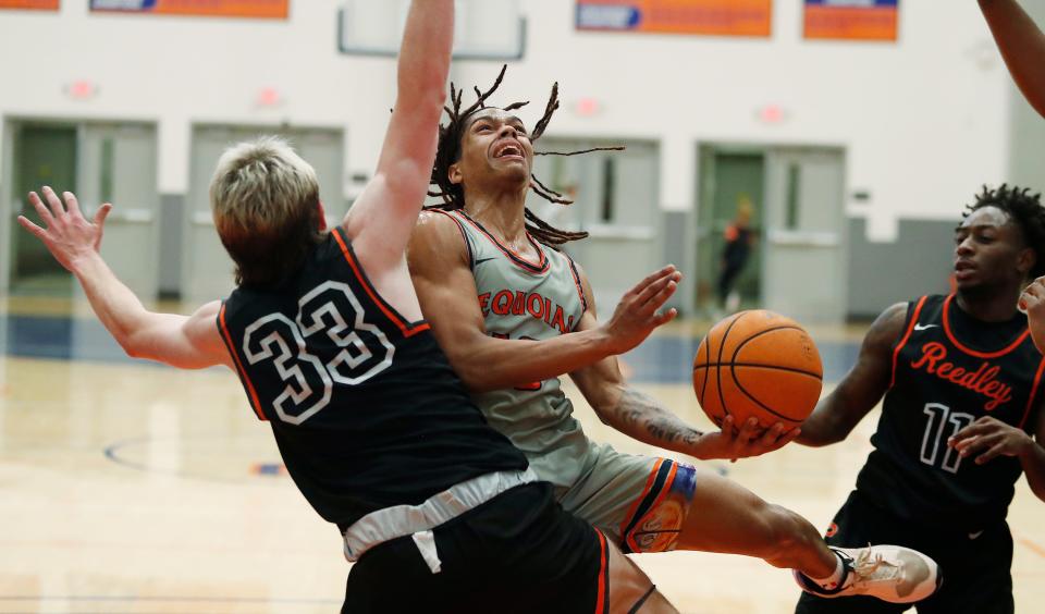 College of Sequoia's Jose Cuello drives strong against Reedley College during their Central Valley Conference junior college menÕs basketball game on Wednesday, Jan. 31, 2024.