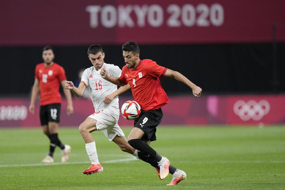 Spain's Pedri Gonzalez, left, and Egypt's Taher Mohamed battle for the ball during a men's soccer match at the 2020 Summer Olympics, Thursday, July 22, 2021, in Sapporo, Japan. (AP Photo/SIlvia Izquierdo)