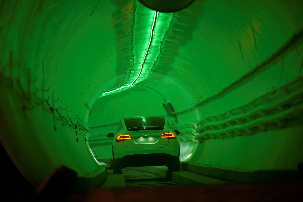 A modified Tesla Model X drives in the tunnel entrance before an unveiling event for the Boring Co. Hawthorne test tunnel in Hawthorne, California, U.S., December 18, 2018.  Robyn Beck/Pool via REUTERS