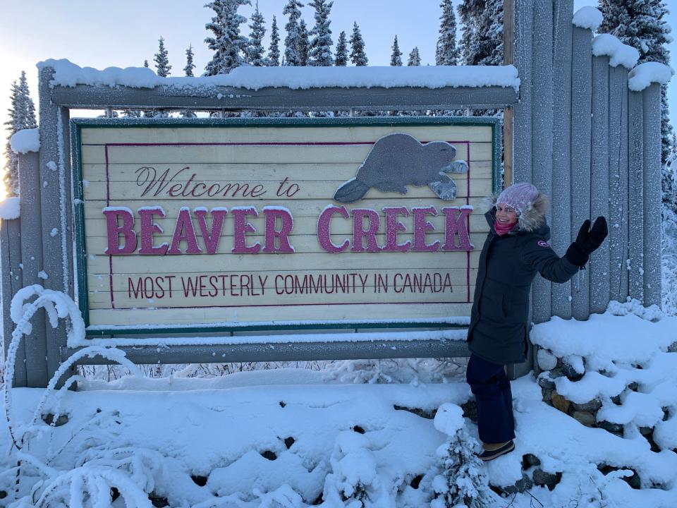 hilary standing next to the welcome to beaver creek sign in the snow