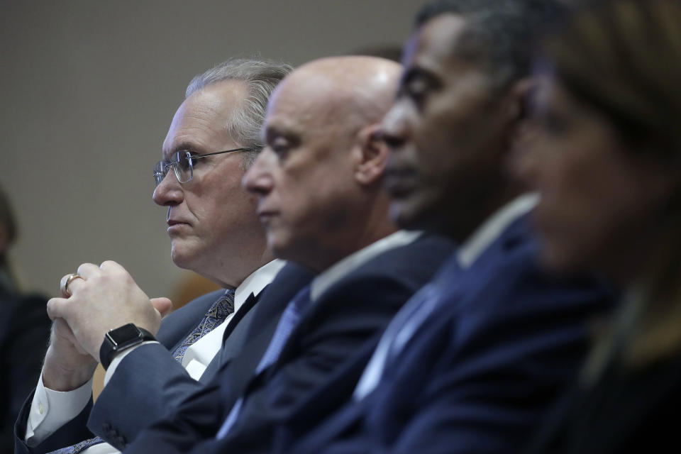 Pacific Gas and Electric Company (PG&E) CEO Bill Johnson, from left, sits with President and CEO Andy Vesey and Senior Vice President, Electric Operations Michael Lewis during a California Public Utilities Commission meeting in San Francisco, Friday, Oct. 18, 2019. (AP Photo/Jeff Chiu)