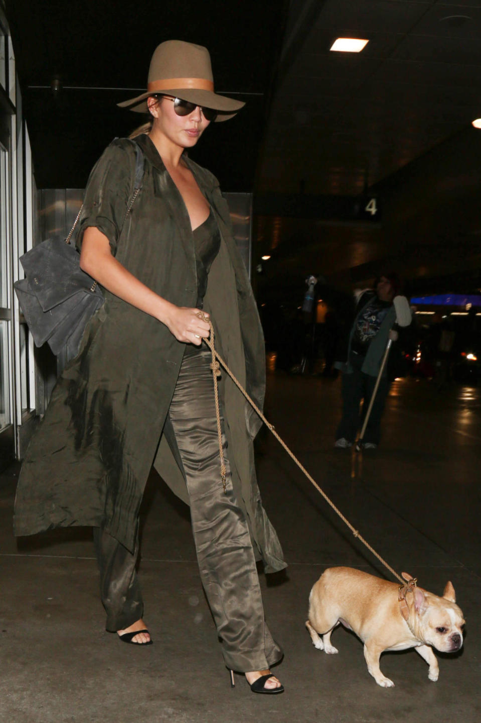 Chrissy Teigen wears a monotoned olive outfit at LAX on Nov. 17, 2015 in Los Angeles, California. 