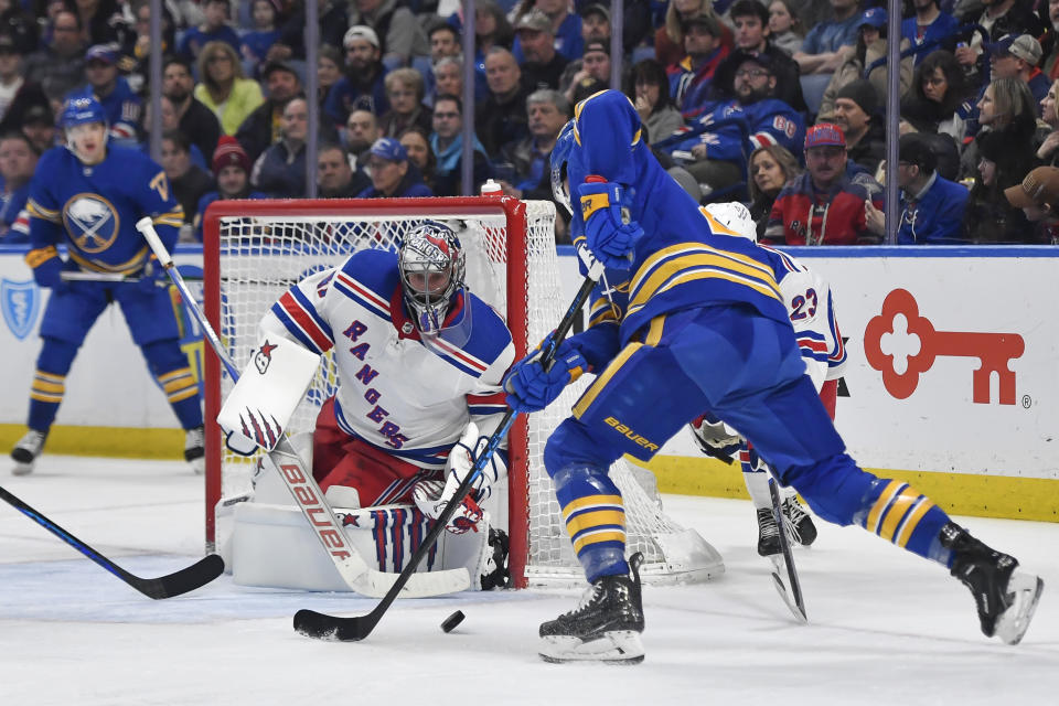 New York Rangers goalie Jaroslav Halak defends against Buffalo Sabres center Dylan Cozens during the second period of an NHL hockey game in Buffalo, N.Y., Friday, March 31, 2023. (AP Photo/Adrian Kraus)