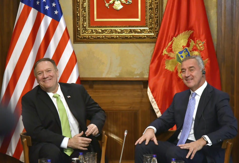 In this photo taken Friday, Oct. 4, 2019, United States Secretary of State Mike Pompeo, left, speaks with Montenegro President Milo Djukanovic, in Podgorica, Montenegro. Deployed inside the sprawling communist-era army command headquarters in Montenegro’s capital, a group of elite U.S. military cyber experts are plotting strategy in a fight against potential Russian and other cyberattacks ahead of the 2020 American and Montenegrin elections. (AP Photo/Risto Bozovic)