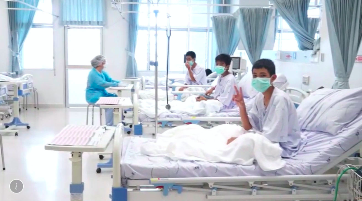 <em>Three of the 12 boys are seen recovering in their hospital beds after being rescued from the cave in Thailand (AP)</em>