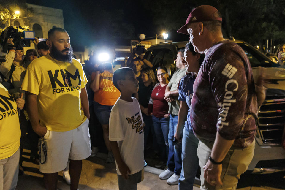 Kimberly Mata-Rubio introduces her 9-year-old son Julian to Cody Smith, after conceding in the mayoral election, Tuesday night, Nov. 7, 2023, in Uvalde, Texas. In Uvalde’s first mayoral race since the Robb Elementary School shooting, Smith won back the job Tuesday over Mata-Rubio, a mother who has led calls for tougher gun laws since her daughter was among the 19 children killed in the 2022 attack. (Sam Owens/The San Antonio Express-News via AP)