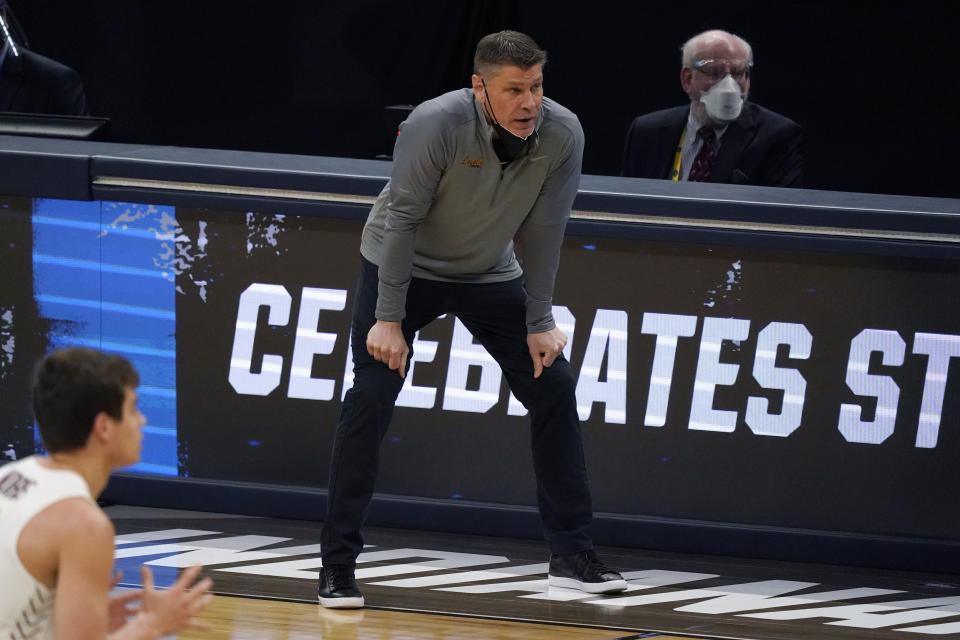 Loyola Chicago head coach Porter Moser watches from the bench during the first half of a Sweet 16 game against Oregon State in the NCAA men's college basketball tournament at Bankers Life Fieldhouse, Saturday, March 27, 2021, in Indianapolis. (AP Photo/Jeff Roberson)