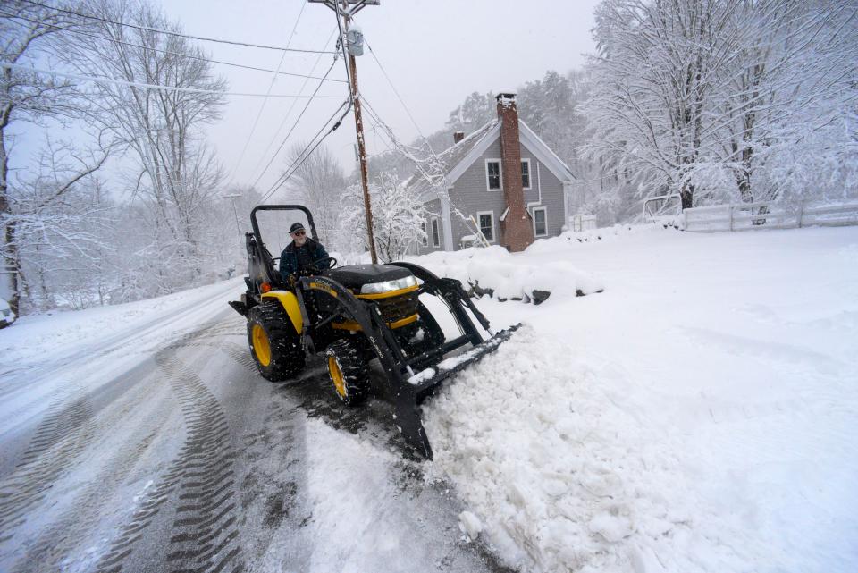 David Herrick of Townshend, Vt., uses a tractor to remove the snow from his driveway on Thursday, April 4, 2024. (Kristopher Radder/The Brattleboro Reformer via AP)