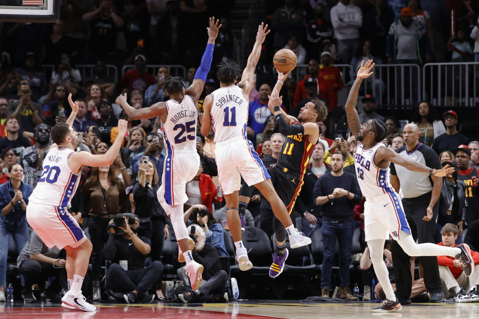 Atlanta Hawks guard Trae Young, second from right, shoots against Philadelphia 76ers guard Jaden Springer (11) during the second half of an NBA basketball game Friday, April 7, 2023, in Atlanta. (AP Photo/Alex Slitz)