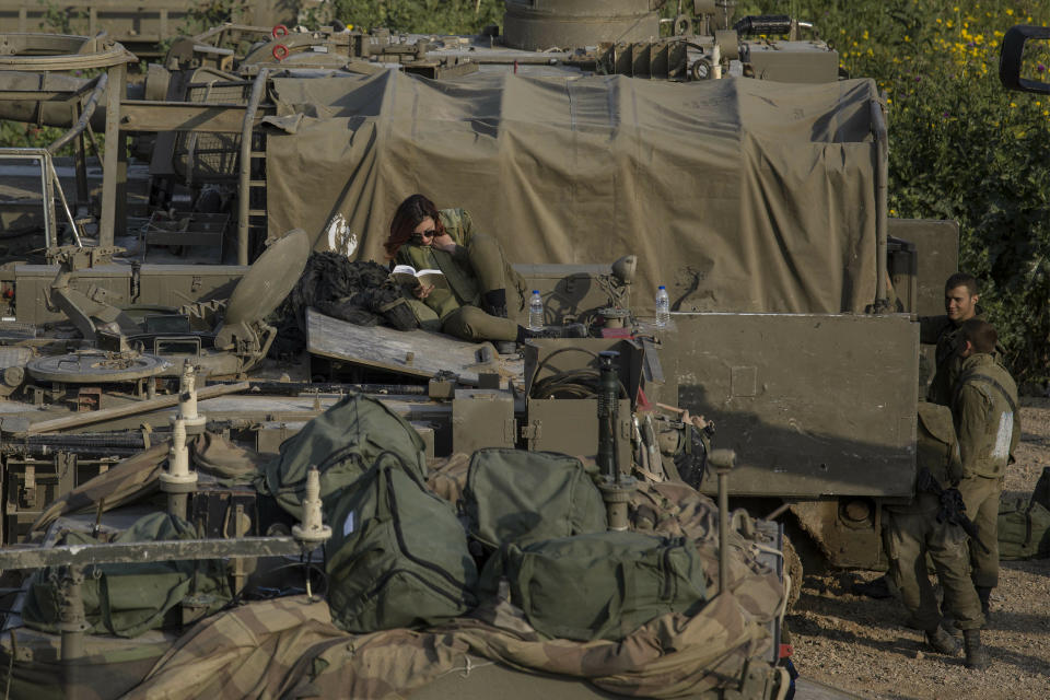 Israeli soldiers sit on top of mobile artillery near the border with Gaza, in southern Israel, Wednesday, March 27, 2019. (AP Photo/Tsafrir Abayov)