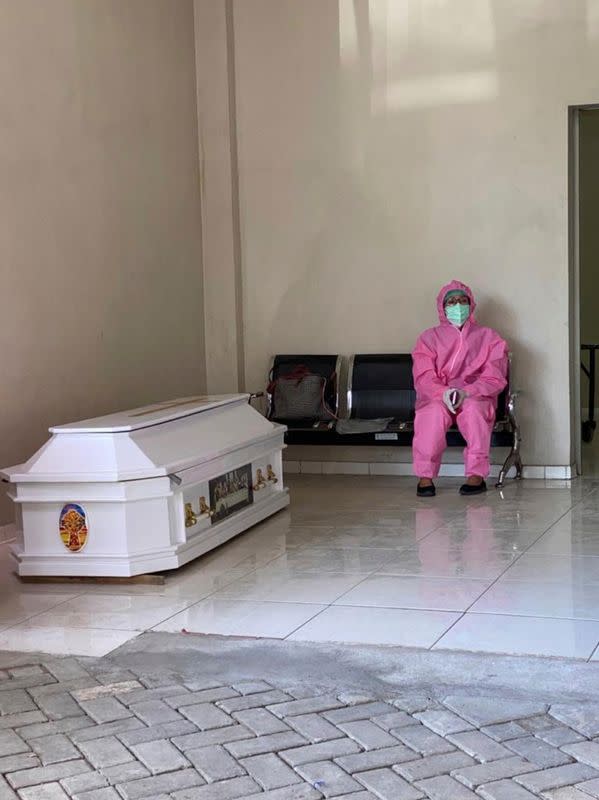 A doctor grieves after her husband, a doctor and chair of the West Papuan doctors' association in Indonesia, died of the coronavirus disease (COVID-19), in Makassar