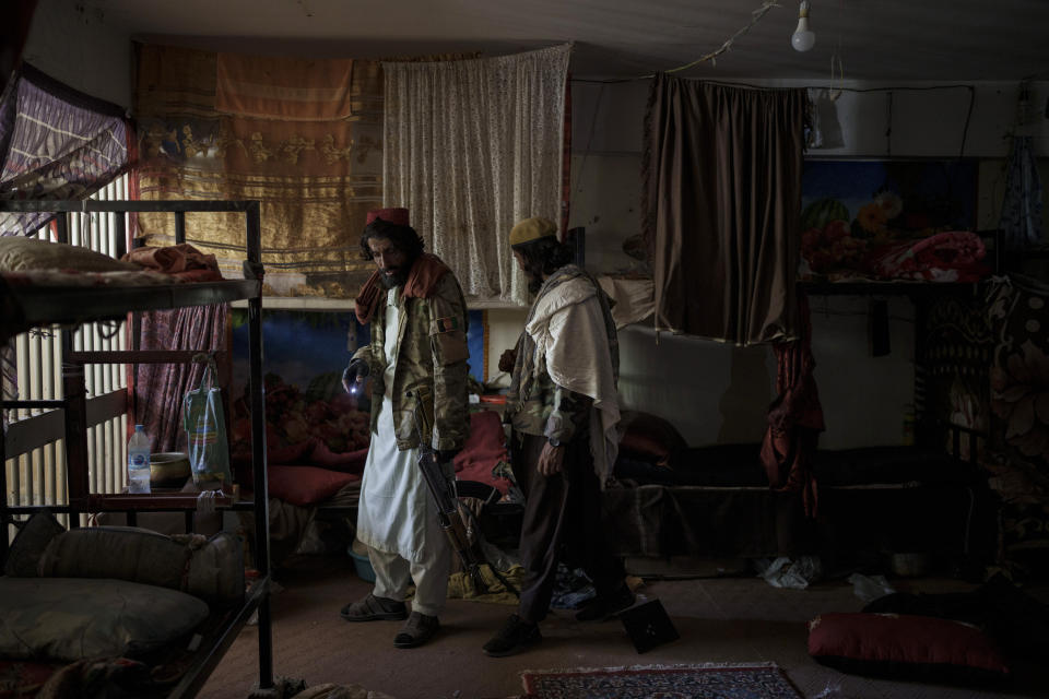 Taliban fighters walk inside an empty cell at the Pul-e-Charkhi prison in Kabul, Afghanistan, Monday, Sept. 13, 2021. Pul-e-Charkhi was previously the main government prison for holding captured Taliban and was long notorious for abuses, poor conditions and severe overcrowding with thousands of prisoners. Now after their takeover of the country, the Taliban control it and are getting it back up and running, current holding around 60 people, mainly drug addicts and accused criminals. (AP Photo/Felipe Dana)