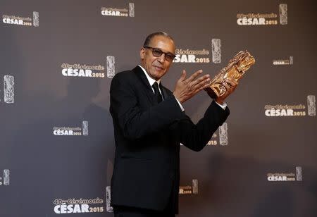 Director Abderrahmane Sissako poses with his trophy during a photocall after winning the Best Director Award for his film "Timbuktu" at the 40th Cesar Awards ceremony in Paris February 20, 2015. REUTERS/Christian Hartmann