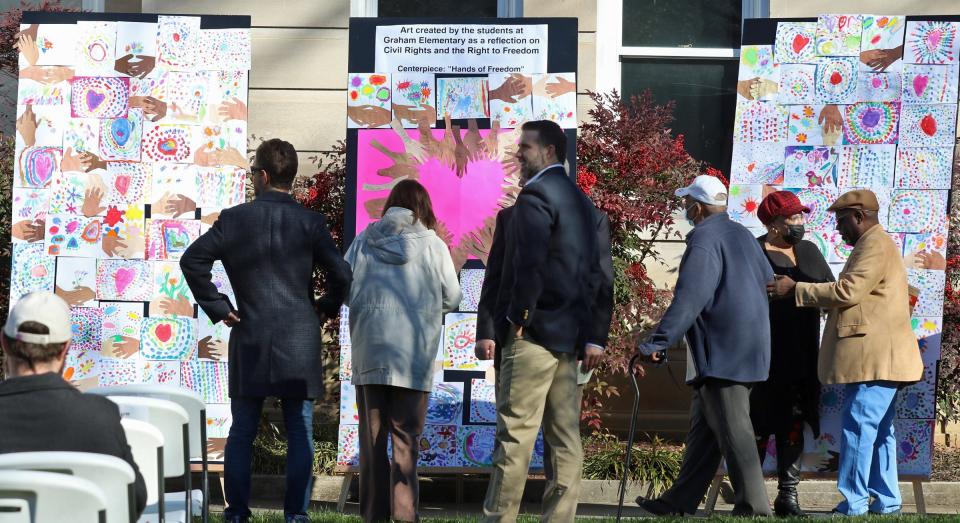 People check out “Hands of Freedom” created by students at Graham Elementary School during the NC Civil Rights Trail Marker Ceremony Saturday morning, Feb. 19, 2022, at Court Square in Shelby.