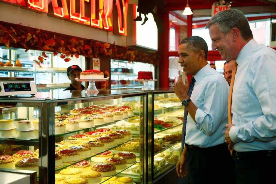 President Barack Obama and Mayor Bill de Blasio visiting Junior’s Cheesecake in Brooklyn in 2013. AP Photo/Charles Dharapak