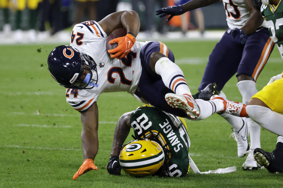 Chicago Bears running back Khalil Herbert (24) is tackled by Green Bay Packers safety Darnell Savage (26) during the second half of an NFL football game Sunday, Sept. 18, 2022, in Green Bay, Wis. (AP Photo/Mike Roemer)