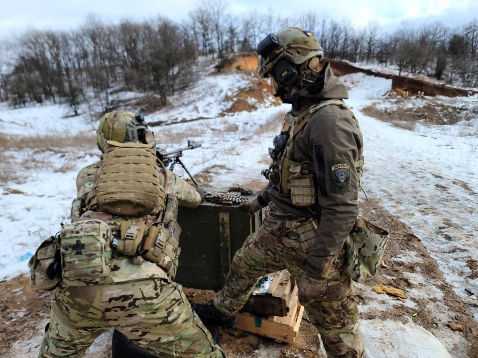 Christopher Campbell and a fellow soldier train at a firing range in eastern Ukraine in winter 2022. (Courtesy)