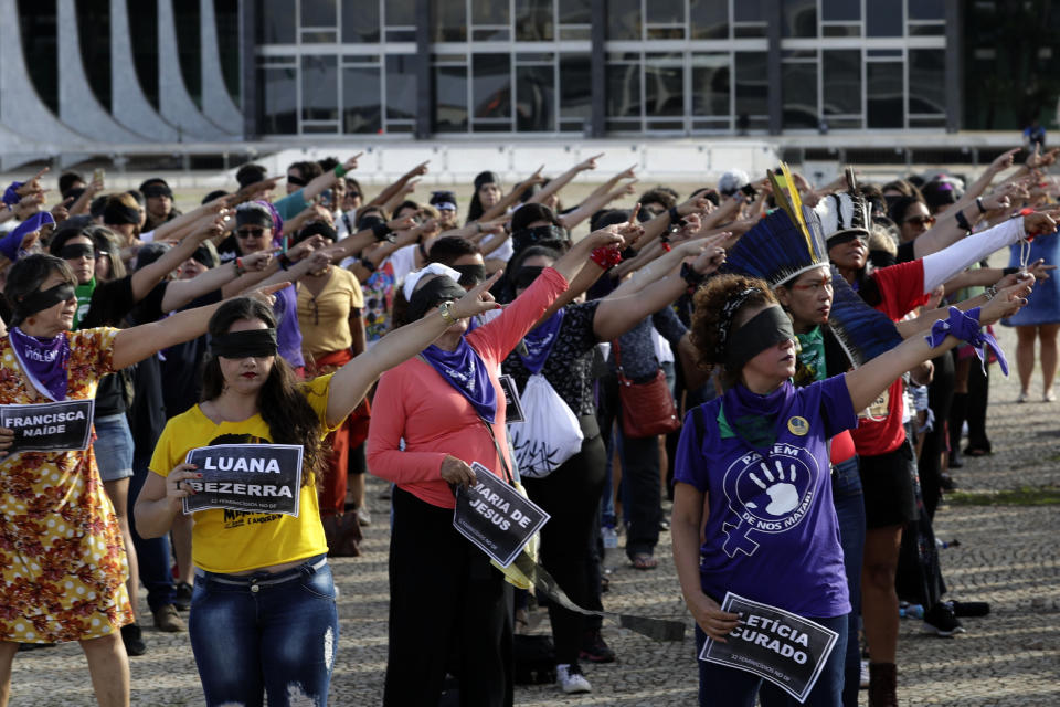 Women perform the feminist anthem "A rapist in your path," in a demonstration against gender-based violence, in front of the Supreme Court, in Brasilia, Brazil, Friday, Dec. 13, 2019. (AP Photo/Eraldo Peres)