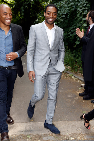 Just days after receiving the honor of being the Commander of the Most Excellent Order of the British Empire (CBE), Chiwetel Ejiofor sat front row next to Suki Waterhouse at the Burberry Menswear Spring/Summer 2016 show wearing a light gray suit with navy blue brogues.