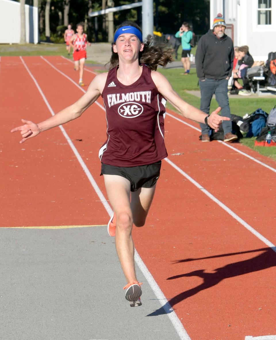 In this October 2021 photo, Henry Gartner of Falmouth approaches the cross country finish line ahead of Jackson Merrill and Jeremy Bullock of Barnstable cross country