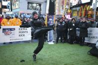 NFL Extra Points Credit Card brand ambassador and Indianapolis Colts placekicker Adam Vinatieri kicks a football to benefit NFL Play60 with a $10,000 donation from NFL Extra Points issued by Barclaycard at the field goal activation on Super Bowl Boulevard in Times Square, Wednesday, Jan. 29, 2014, in New York. (John Minchillo/AP Images for Barclaycard)