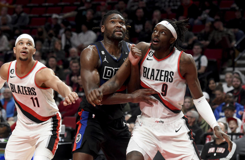 Portland Trail Blazers guard Josh Hart, left, and forward Jerami Grant, right, battle for position with Detroit Pistons center Isaiah Stewart, center, under the basket during the second half of an NBA basketball game in Portland, Ore., Monday, Jan. 2, 2023. The Blazers won 135-106. (AP Photo/Steve Dykes)