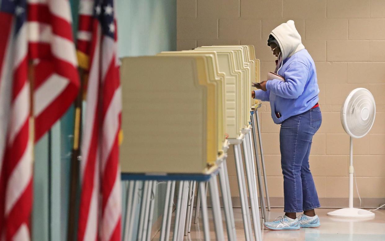 Deonna Swezey, 31, fills out her ballot for mayoral candidate Shammas Malik during the primary election Tuesday at Firestone Park Community Center in Akron.