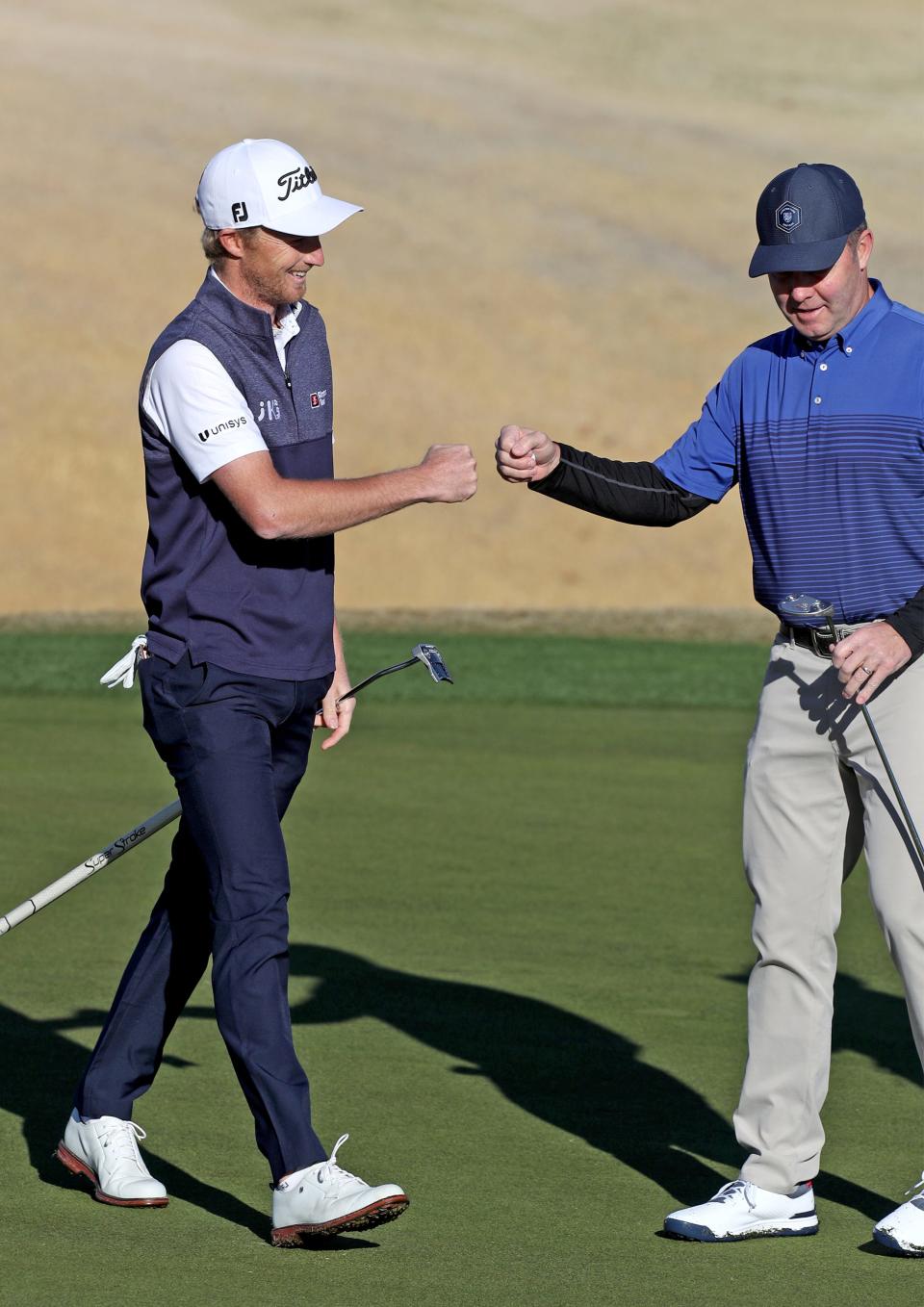 USGA CEO Mike Whan, right, fist bumps Will Zalatoris, left, on the 11th green of the Nicklaus Tournament Course during the first round of The American Express in La Quinta, Calif., on Thursday, Jan. 19, 2023.