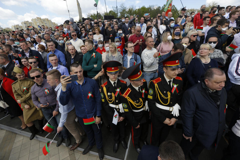 People attend the Victory Day military parade that marked the 75th anniversary of the allied victory over Nazi Germany, in Minsk, Belarus, Saturday, May 9, 2020. Belarus remains one of the few countries that hadn't imposed a lockdown or restricted public events despite recommendations of the World Health Organization. (AP Photo/Sergei Grits)