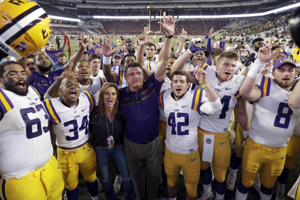 LSU coach Ed Orgeron celebrates with players after an NCAA college football game against Texas A&M Thursday, Nov. 24, 2016, in College Station, Texas. LSU won 54-39. (AP Photo/David J. Phillip)