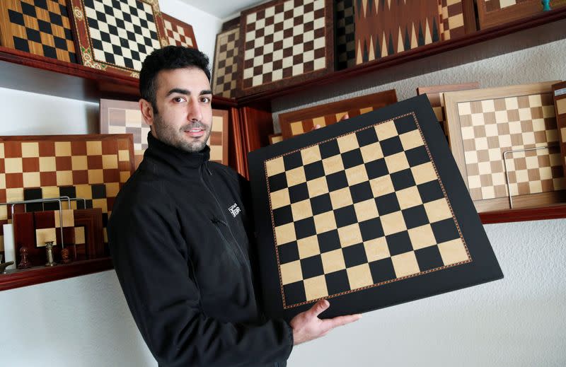 David Ferrer poses with a chessboard at the Rechapados Ferrer factory in La Garriga