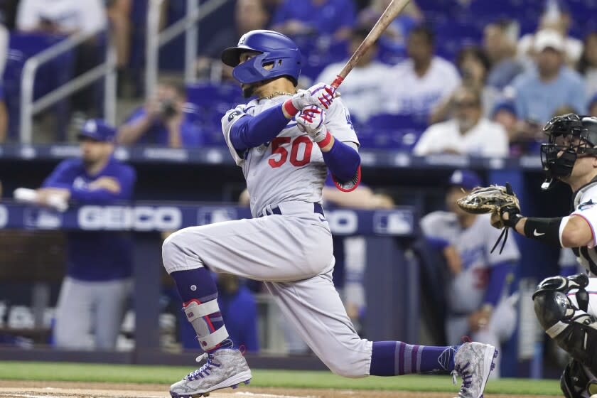 Los Angeles Dodgers' Mookie Betts (50) hits a home run in the first inning.