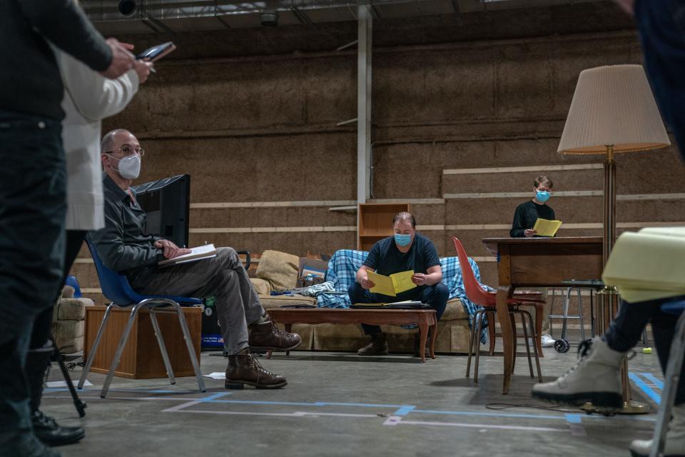 Brendan Fraser (center) reads through a scene with director Darren Aronofsky and co-star Ty Simpkins on the set of "The Whale."