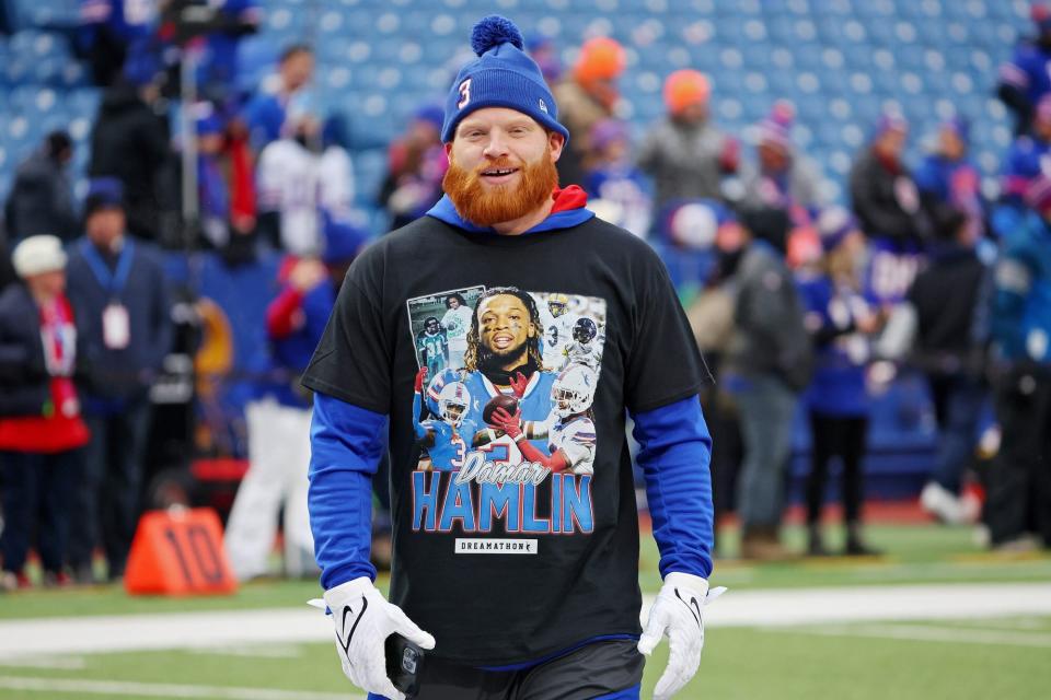 ORCHARD PARK, NEW YORK - JANUARY 08: Tyler Matakevich #44 of the Buffalo Bills watches pregame before a game against the New England Patriots while wearing a shirt and hat in support of Buffalo Bills safety Damar Hamlin at Highmark Stadium January 8.  2023 in Orchard Park, New York.  Hamlin suffered cardiac arrest during the Bills' Monday Night Football game against the Cincinnati Bengals and remains in intensive care.  (Photo by Timothy T. Ludwig/Getty Images)